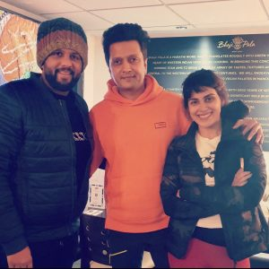 Guests posing in front of the Bhaji Pala menu wall